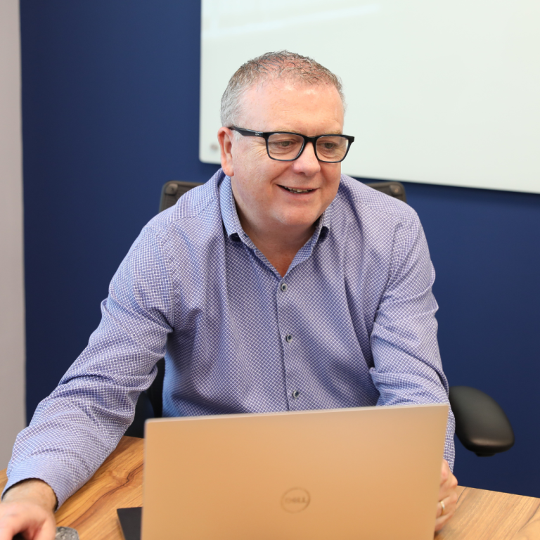 photo of nigel power in a office meeting clients